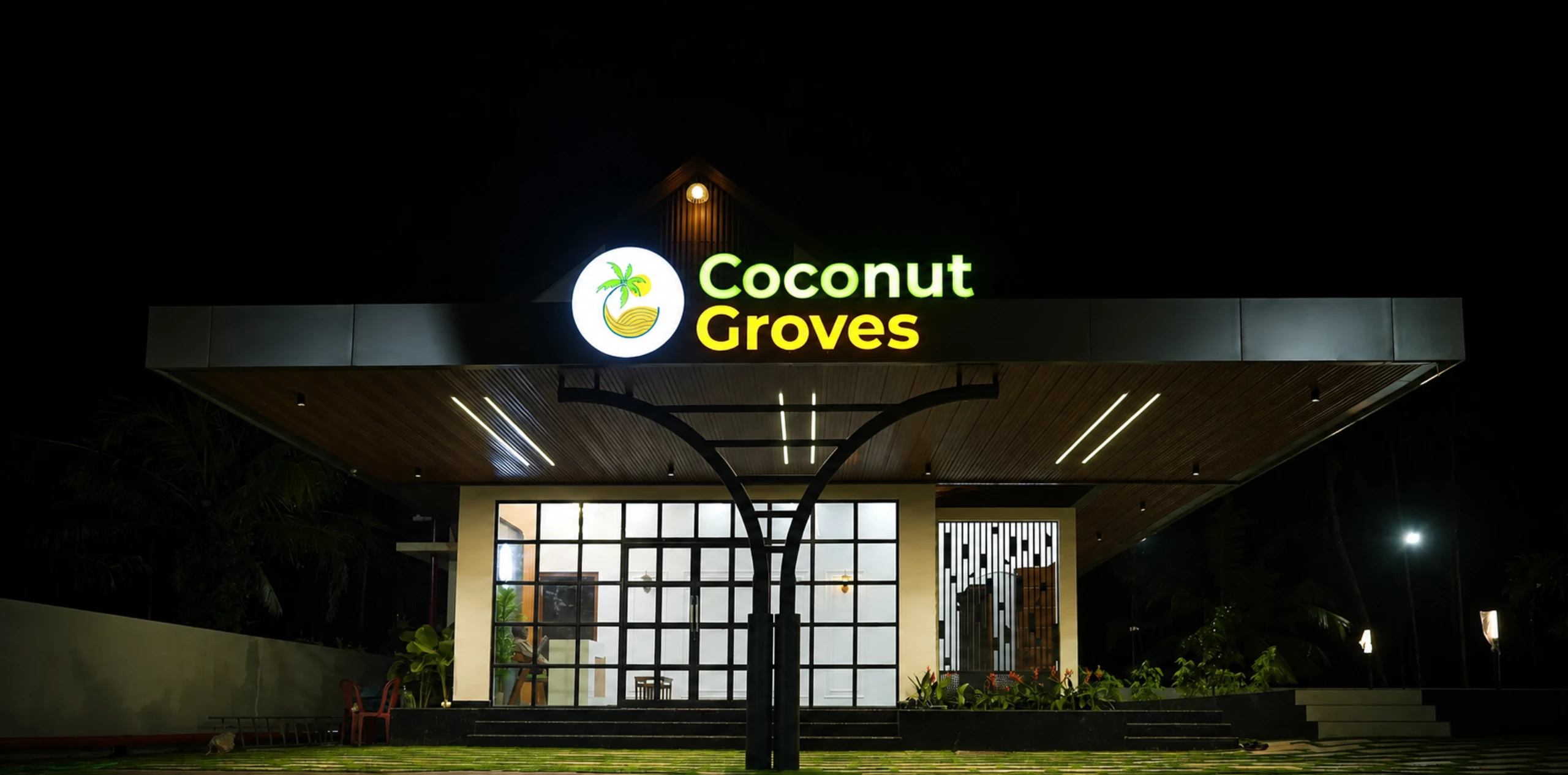 Coconut Groves welcome entrance illuminated at night